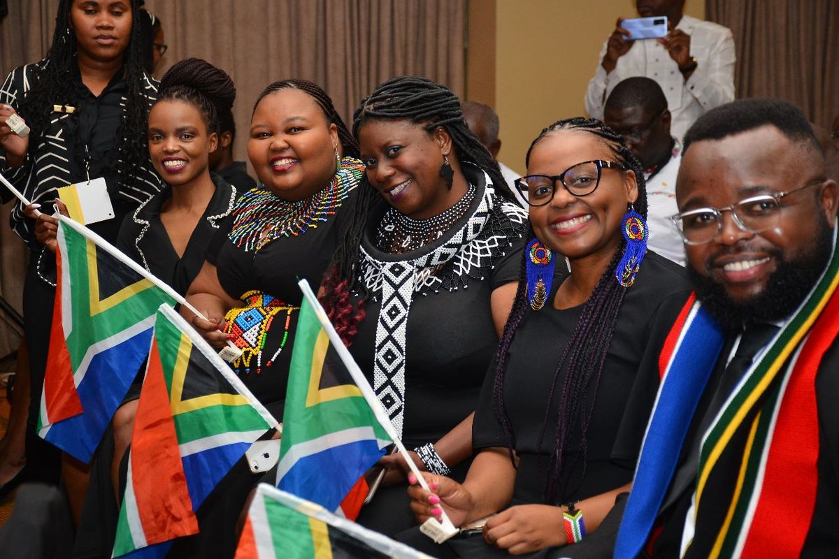 JCI South Africa members waving South African flags